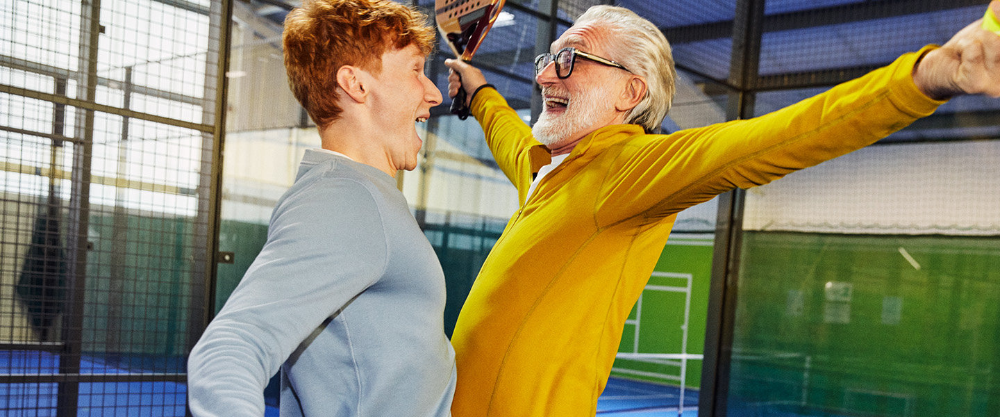 Zwei Männer feiern ausgelassen einen Punkt beim Padel spielen.