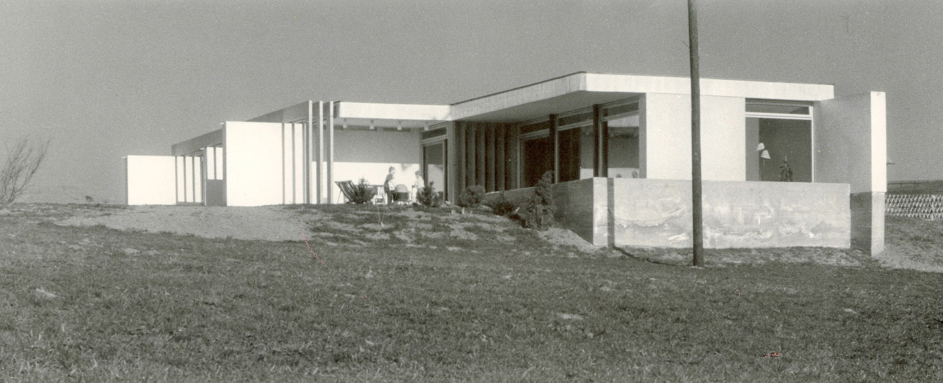 Bild in schwarz weiß mit einem einstöckigen Einfamilienhaus