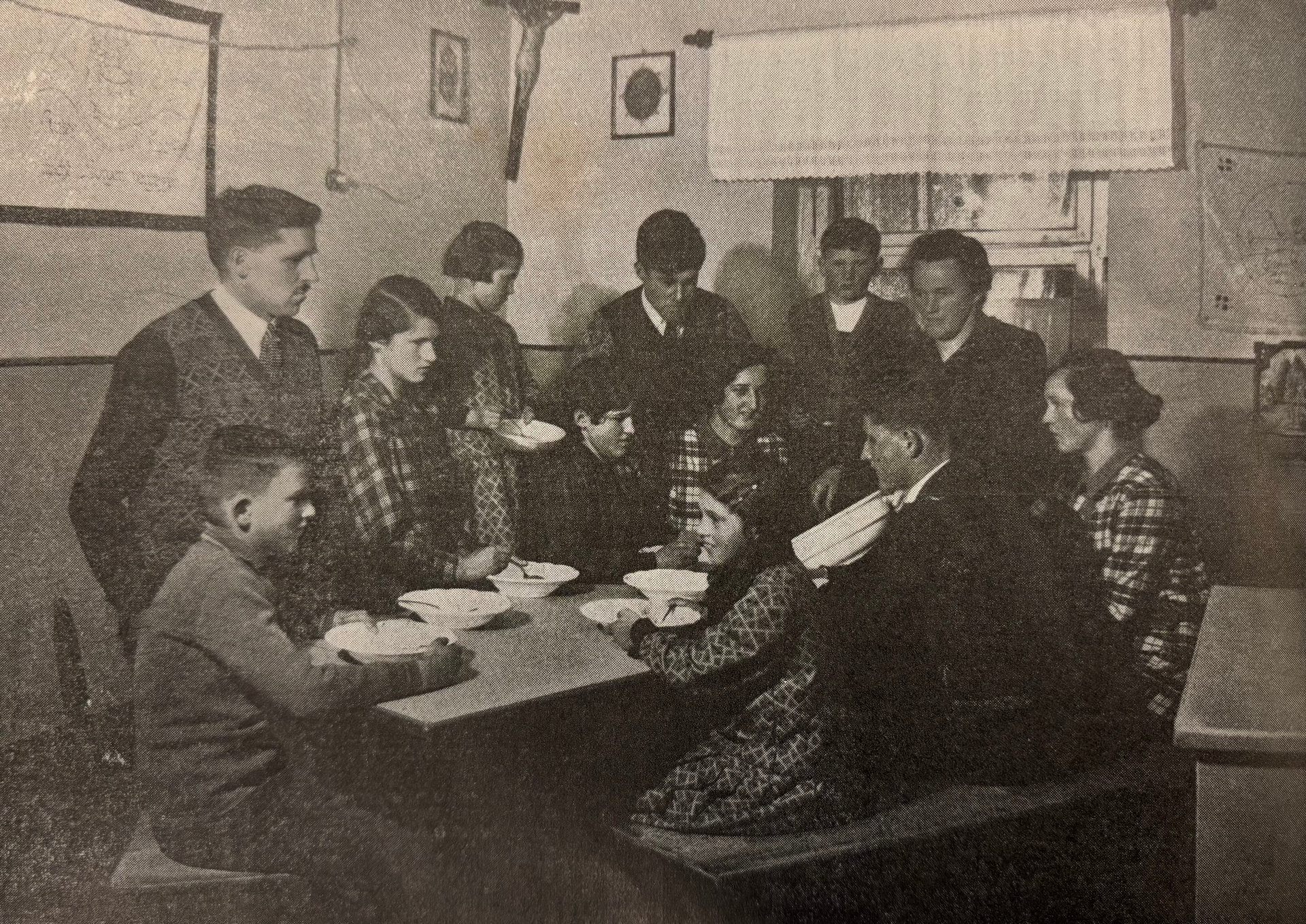 alte Aufnahme einer Großfamilie rund um einen Küchentisch