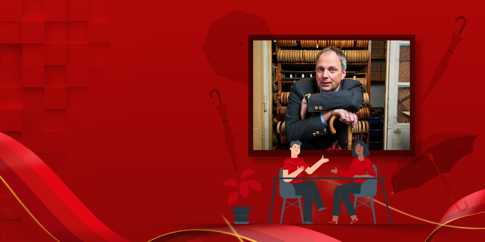 Interviewsituation mit einem Mann und einer Frau im Gespräch an einem Tisch. Im Hintergrund das Bild des Interviewpartners von Kirchtag Schirme: Andreas Kirchtag