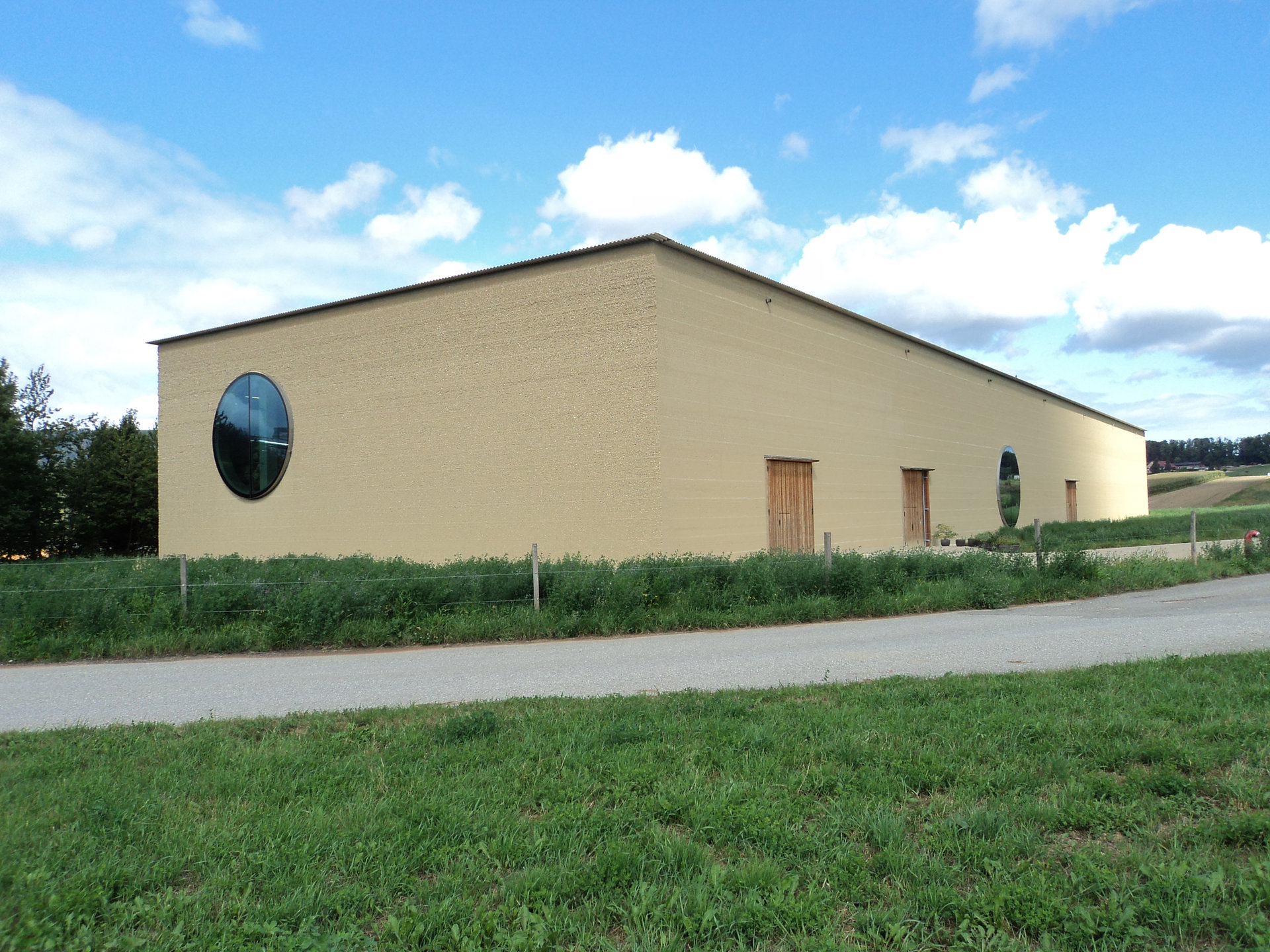 Ein gelbes Haus auf einer Wiese.