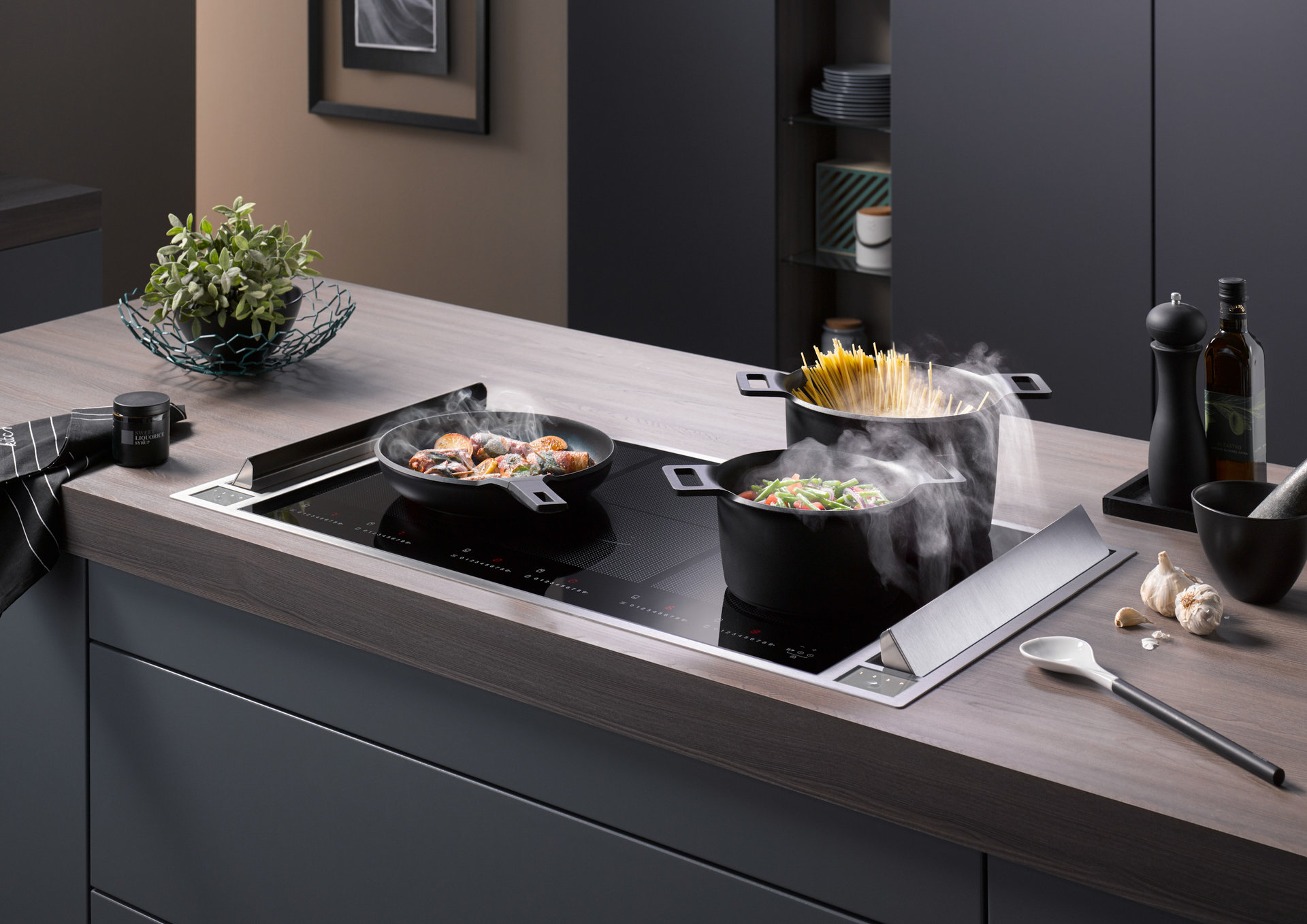 Ein sogenannter Muldenheber saugt den Dampf neben dem Herd und nicht darüber ab. Dadurch sparst du dir einen Oberschrank, brauchst aber Platz im Unterschrank. | Copyright: © tdx/Homeier