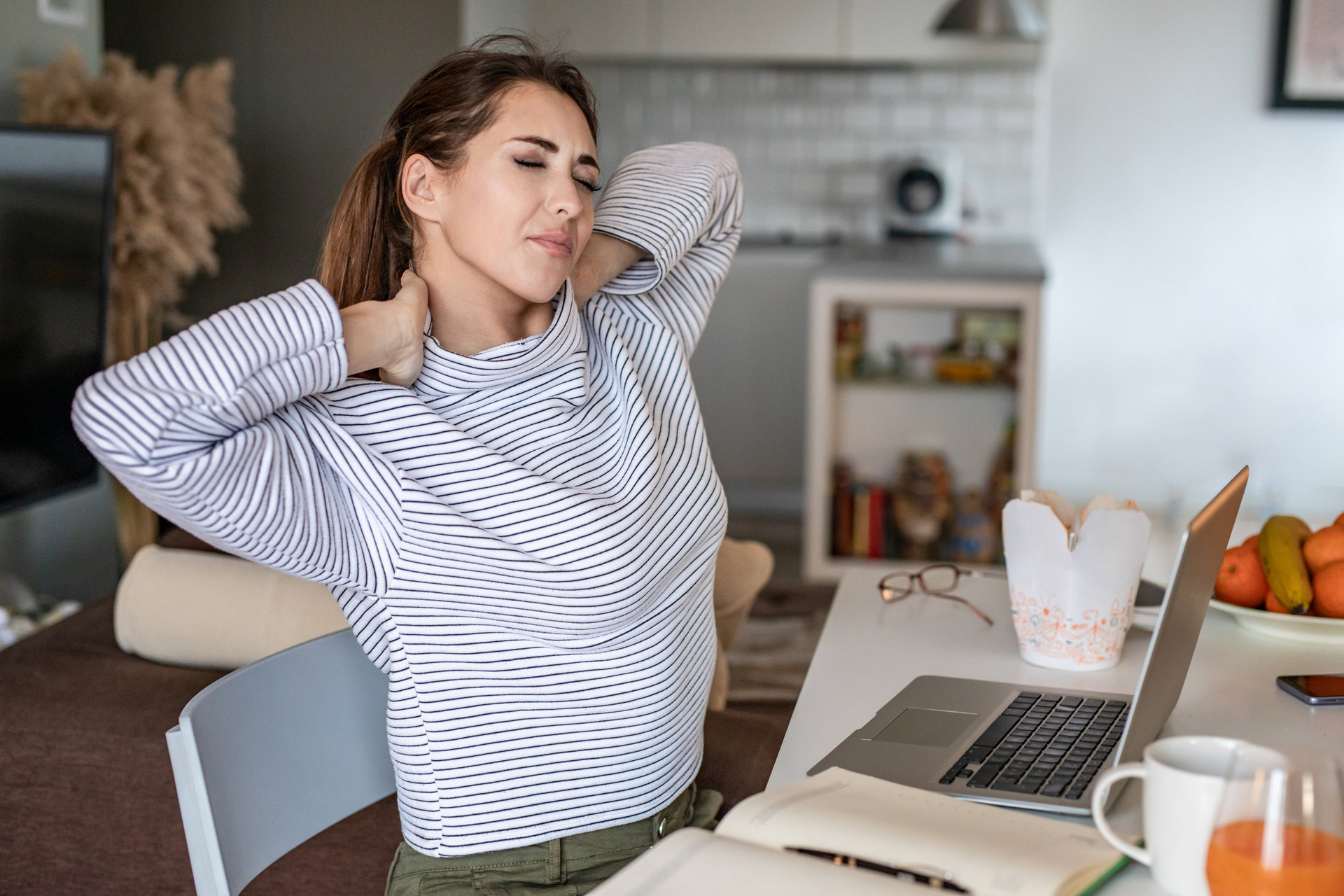 Photo of a woman at home and having pains