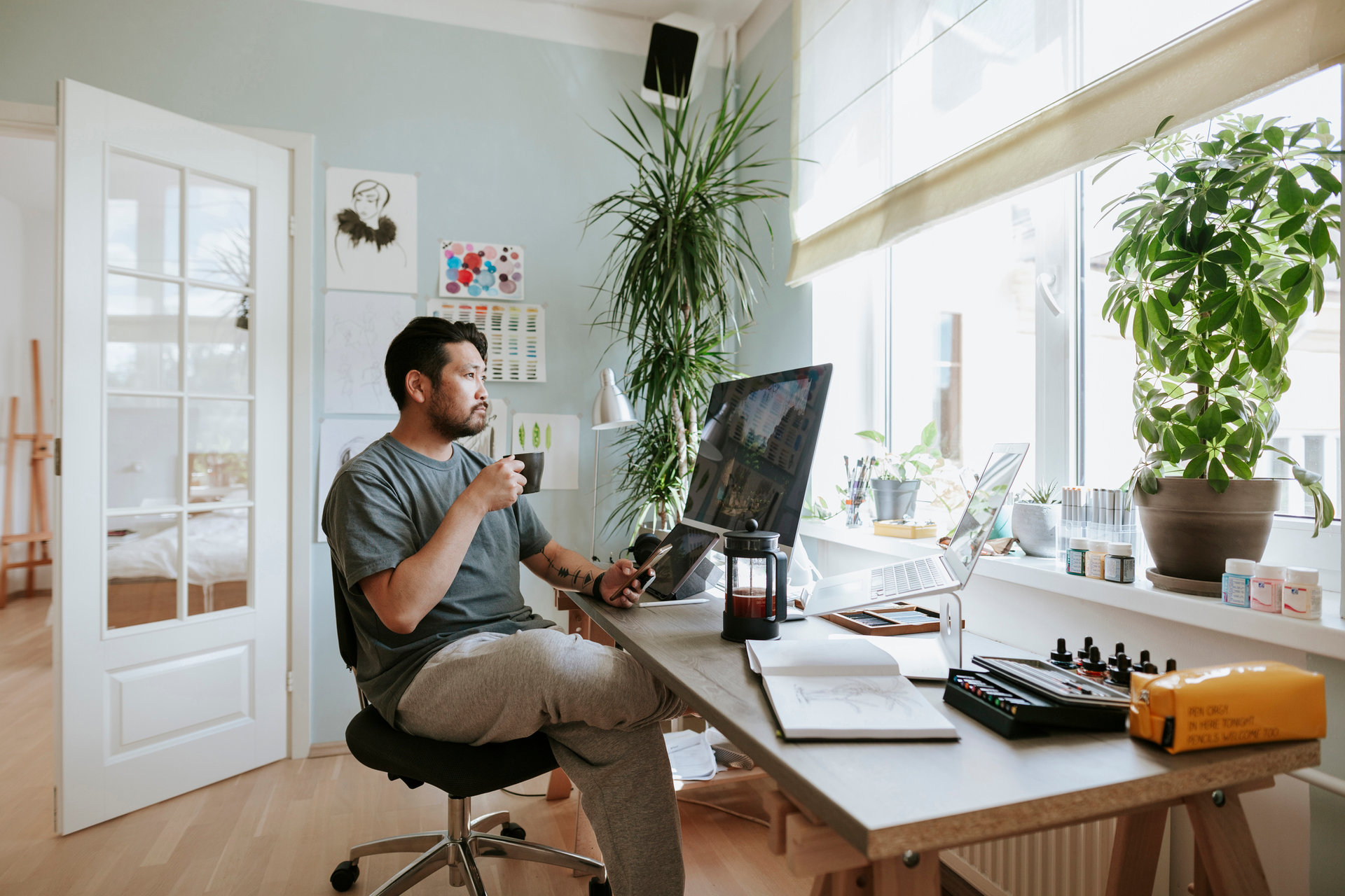 Photo series of Japanese digital artist at his home studio taking a coffee break.