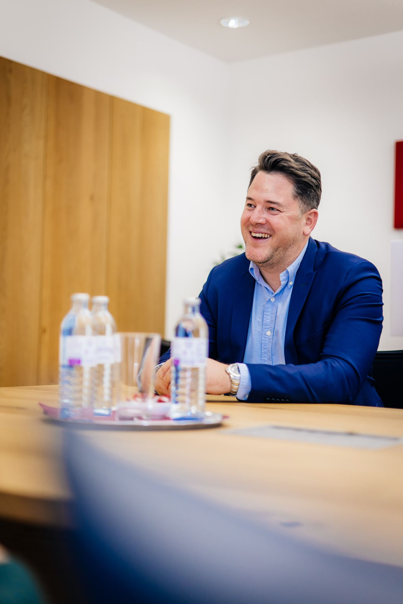 Foto von Wüstenrot CCO Tobias Kohl bei einem Gespräch, er lacht herzlich