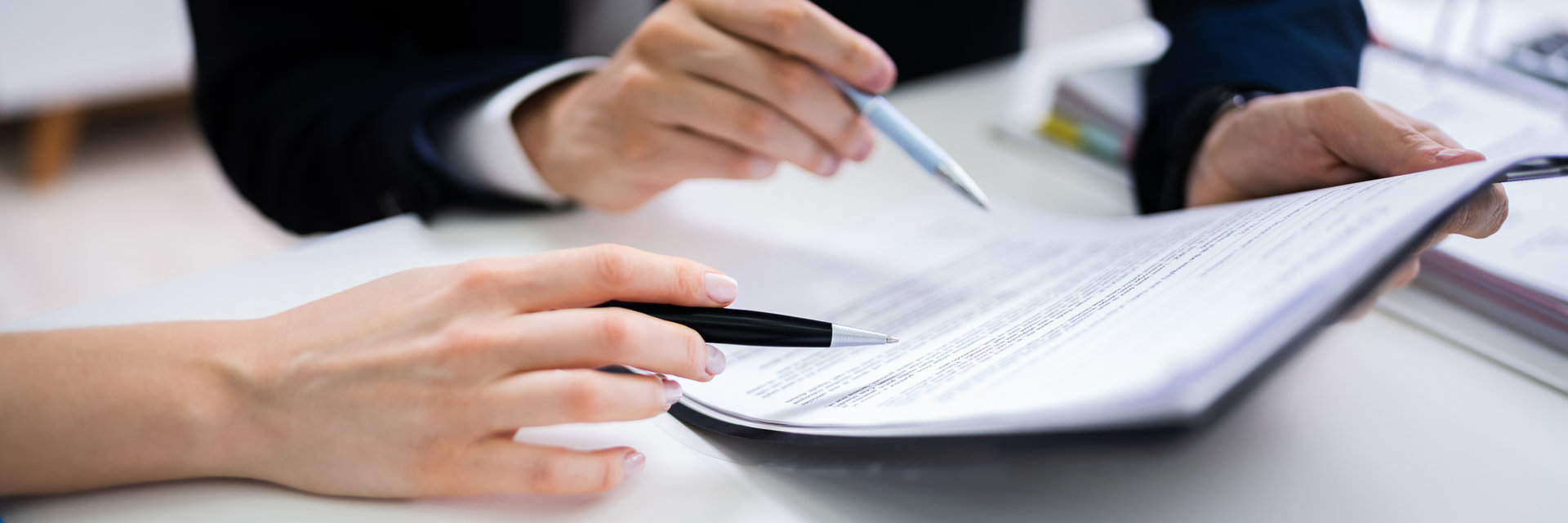 Time to say good bye Two Businesspeople Hand Analyzing Document Over Glass Desk